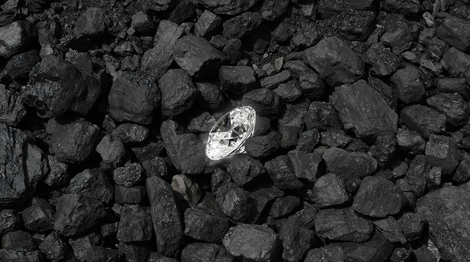 a diamond surrounded by coal